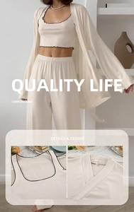 Detail of cream lounge set showing black wavy trim on camisole and soft fabric texture