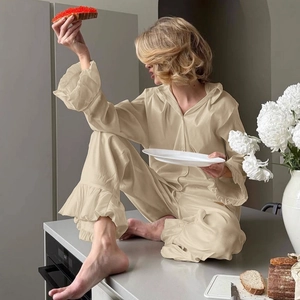 Women's satin beige lounge set with elegant ruffle hem sleeves and button-down pajamas
