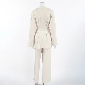 Rear view of beige lounge set featuring belted long sleeve cardigan and wide-leg pants