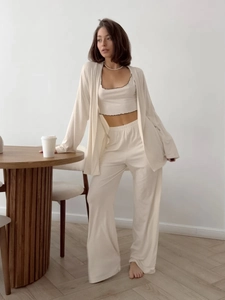 Three-piece lounge set featuring a soft apricot cardigan, ruffled camisole, and wide-leg pants