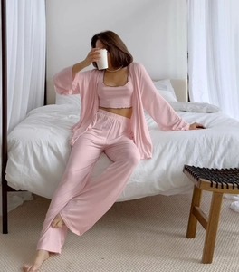Detailed view of pink three-piece lounge set with ribbed texture and ruffle trim hem