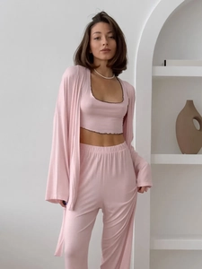 Detailed view of apricot three-piece sleepwear set with delicate black ruffle trim details