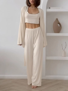 Detail view of cream three-piece loungewear set featuring ribbed fabric and lettuce edge trim