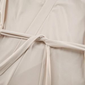 Detail of waist tie knot and soft knit texture on beige three-piece loungewear set