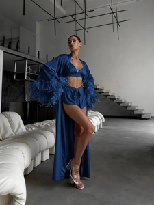 Detail of luxury royal blue satin robe with ostrich feather trim on the sleeves