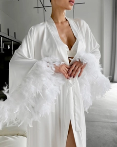 Luxurious white satin robe featuring elegant feather trim cuffs and silky fabric texture