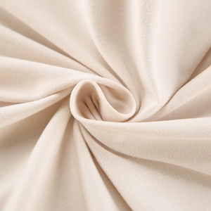 Detailed macro view of soft cream knit milk silk fabric with fine woven texture