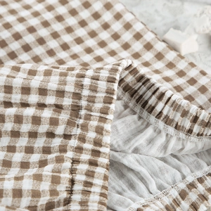 Detailed macro view of elastic waistband on cotton plaid pajama pants with textured fabric