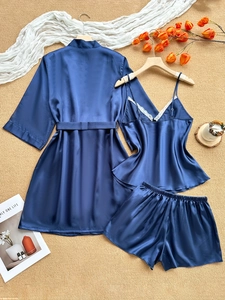 Three-piece satin pajama set in dark blue featuring lace trim camisole and matching robe