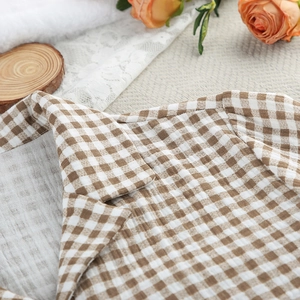 Close-up of checkered cotton pajama collar with brown plaid pattern and neat stitching