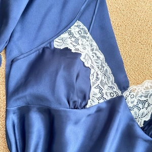 Navy blue satin sleepwear set with white lace trim and silky texture for women
