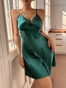 Detailed view of dark green silk satin nightgown featuring elegant lace trim on the V-neckline