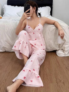 Detail view of pink heart striped pajama pants with ruffled hem and breathable cotton fabric