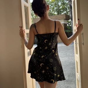Elegant black satin slip nightdress with gold star and moon patterns for women