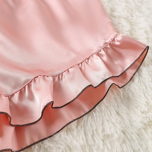 Pink satin 3-piece pajama set with black contrast trim and ruffled edges for women