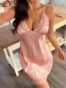 Close-up of pink satin nightgown with delicate lace trim on V-neckline and hem