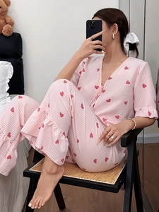 Detail of pink striped pajamas with red heart prints and delicate ruffle trim edges
