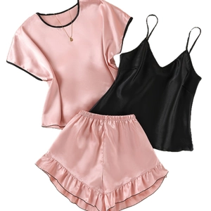 Three-piece pink and black satin pajama set with camisole, short sleeve top and ruffle shorts