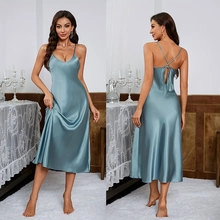 Detailed back view of satin slip dress showing crossed straps and open back design