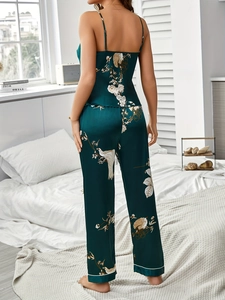 Details von dunkelgrünem Satin-Pyjama-Set mit Blumenmuster und weißen Paspeln am Saum