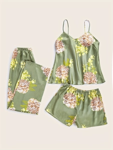 Flat lay of 3-piece floral satin pajama set in sage green with tank top, pants, and shorts