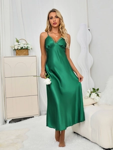 Close-up of emerald green satin nightgown featuring elegant lace trim on the V-neckline