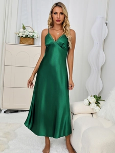 Close-up of emerald green satin nightgown with elegant eyelash lace trim on V-neckline