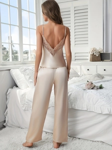 Detail of champagne gold silk camisole back with deep V-neck and delicate lace trim
