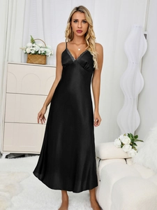 Detail of elegant black satin nightgown with V-neckline and grey lace trim decoration
