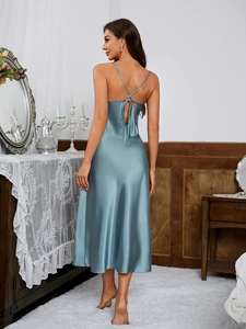 Detail of cross-back straps on a grey-blue satin nightgown with elegant silk texture