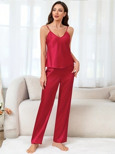 Detail of red satin pajama set with V-neck camisole and lace pants for luxury loungewear