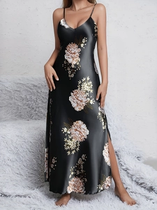 Detail of black floral satin nightgown showing silk texture and side slit design