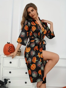 Detail of Halloween pumpkin and spider web print on silky black kimono robe for women