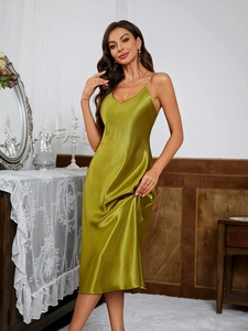 Detailed close-up of olive green silk satin slip dress with deep V-neck and thin straps