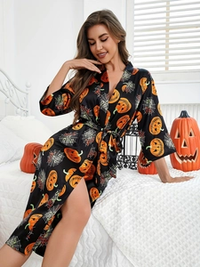 Detail of Halloween satin robe with orange pumpkin and spider web patterns