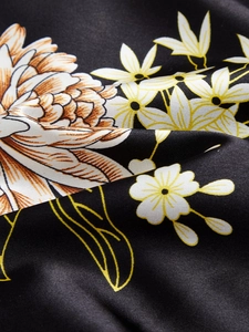 Close-up of elegant floral print on satin fabric showing smooth silky texture and drape