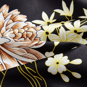 Elegant floral print satin camisole set with intricate orange and daisy patterns