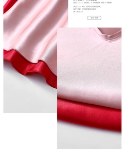 Detail of pink and red satin camisole showing silk texture and V-neck stitching