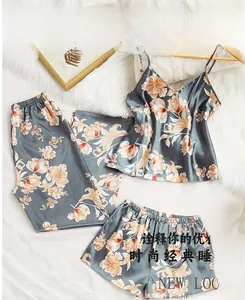 Detailed flat lay of a floral satin three-piece pajama set with tank top and pants
