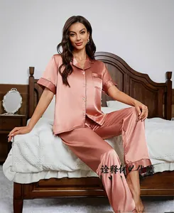 Women's pink silk satin pajama set with short sleeves and pants in home bedroom setting