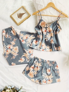 Detailed flat lay of floral satin three-piece sleepwear set with tank top and pants