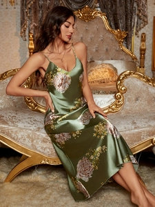 Detail of olive green satin long nightdress featuring elegant white floral prints