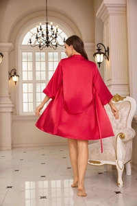 Detailed back view of red satin silk robe with waist tie in a luxury room setting
