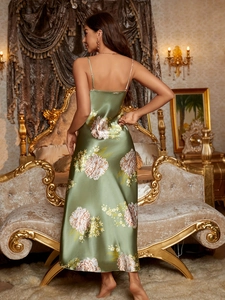 Rear view of an olive green satin floral nightgown showing drape and silky texture