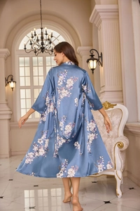 Detail of elegant dusty blue floral satin robe with silk texture and midi length