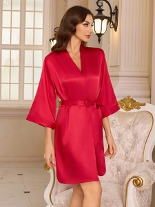 Close-up of luxury red silk satin bathrobe with classic V-neck and elegant waist tie