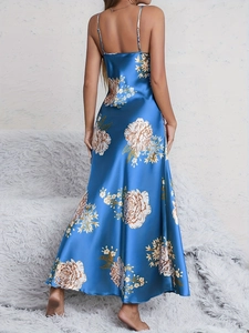 Detail of the open back design on a blue floral satin slip dress with a silky finish