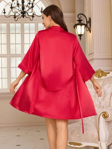 Rear view of red silk satin bathrobe with waist tie in a luxury European room