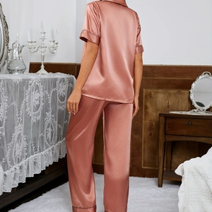 Women's pink silk satin pajama set with short sleeves and long pants seen from behind