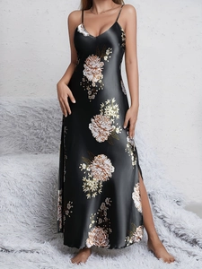 Detail of black floral satin nightgown featuring side slit and high-gloss silk-like fabric